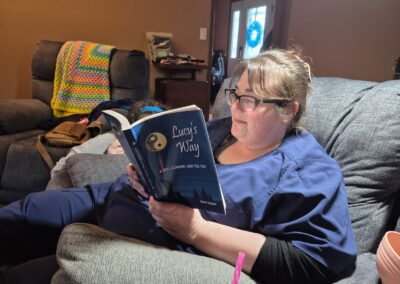 Person reading Lucy’s Way by Mark Saluke
