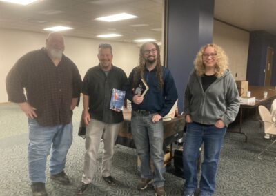 Left to Right: Bob Freeman, Mark, Connor Freeman and Kim Freeman at Marion Public Library Harvesting Our Stories local author fair on November 15, 2025.