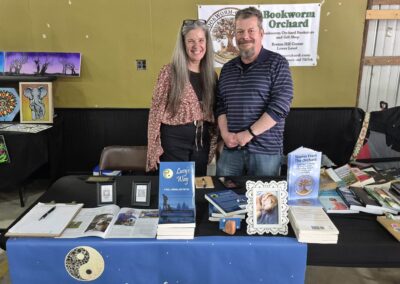 Mark and Wende (partner in crime, best friends, Reiki Master and many other hats) repping Bookworm Orchard during Summerween at Cass County Fairgrounds in Logansport, IN, May 23, 2026.