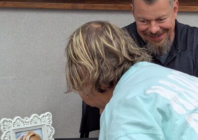 Lucy grabs another fan at Elwood Public Library, August 8, 2026.
